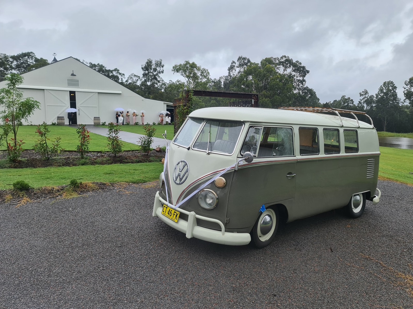 Mouse-grey split-screen VW Kombi with wedding ribbons